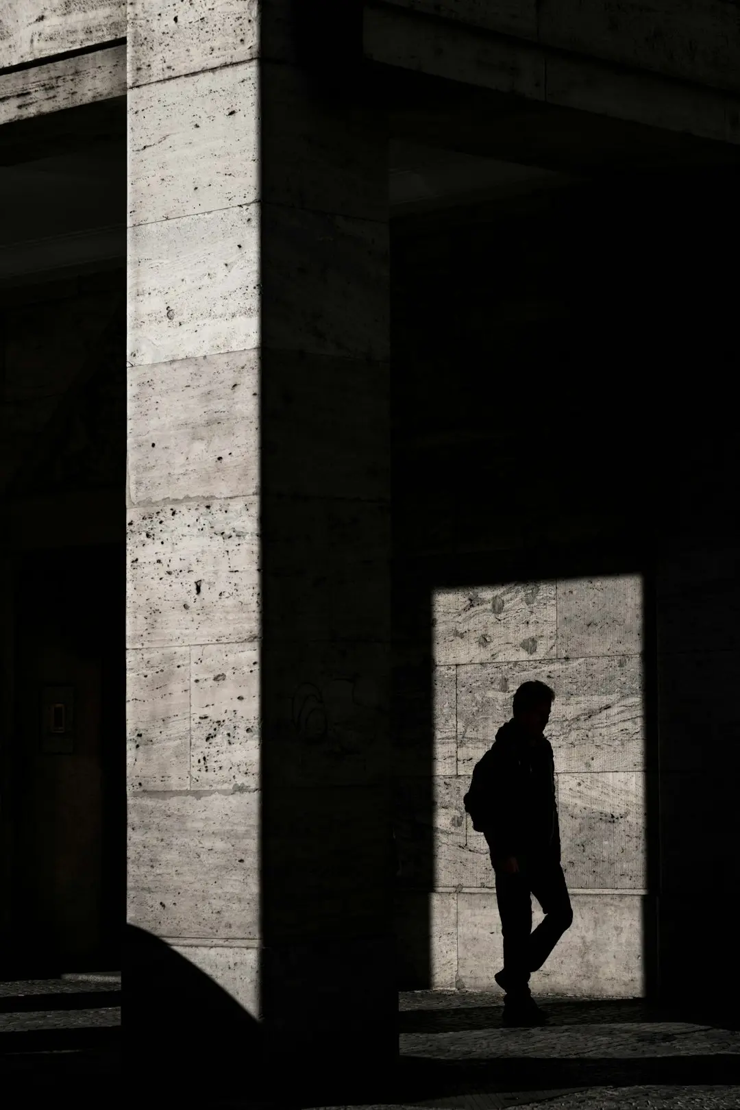 shadow silhouette of man standing inside structure