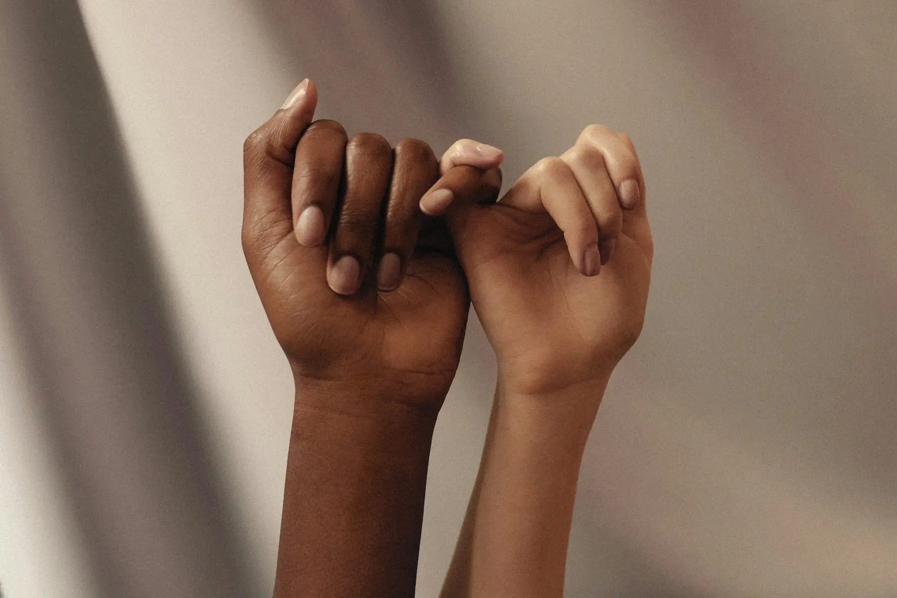 hands of two people making a pingy swear